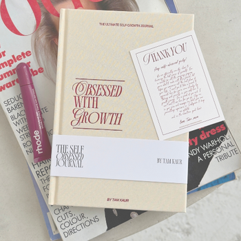 Book titled 'Obsessed with Growth' on a magazine with visible text and branding.